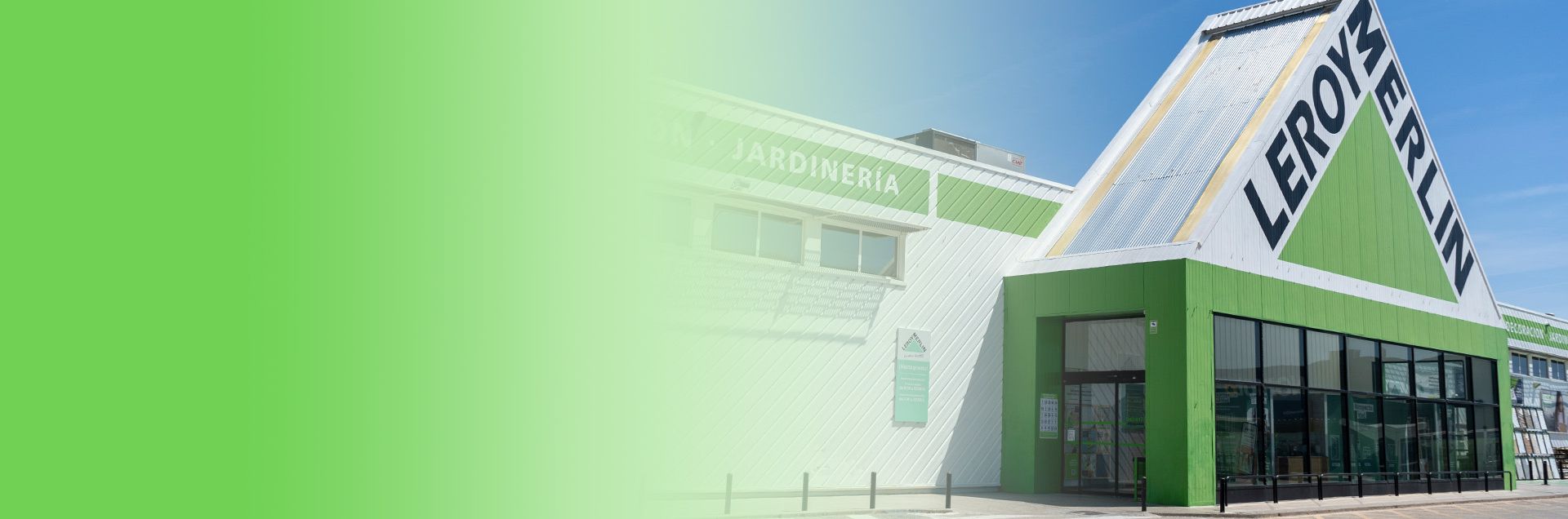 Leroy Merlin store exterior with a green facade and large signage against a clear blue sky.